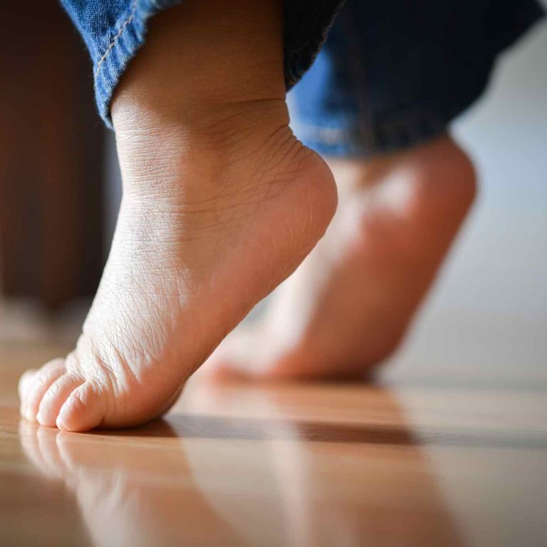 Infant Child's Feet On Tippy Toes - Innocence Concept